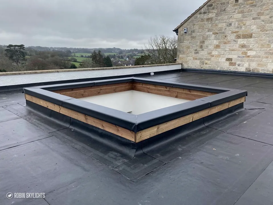 Empty timber upstand on a flat roof, ready for the rooflight