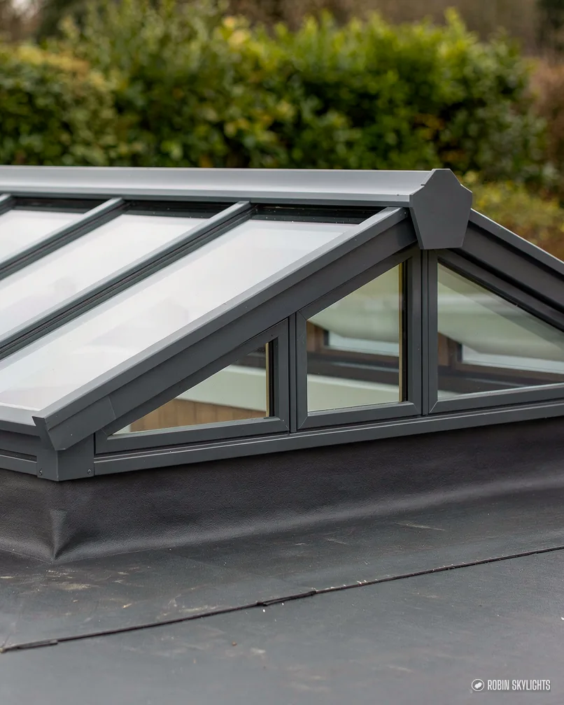 Close view of a roof lantern with dark glazing bars on a flat roof