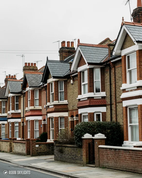 Street of Victorian red brick terraced houses with gables