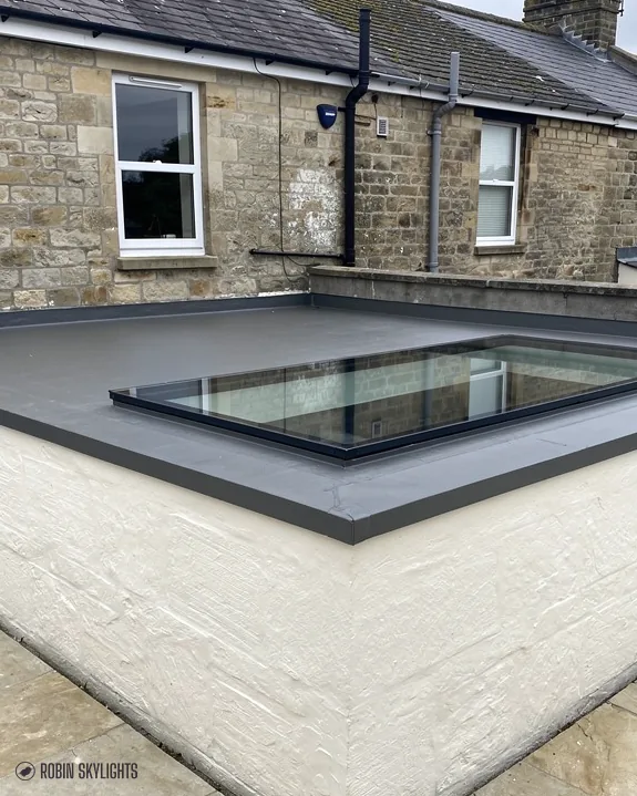 Flat rooflight on a roof below stone terraced houses