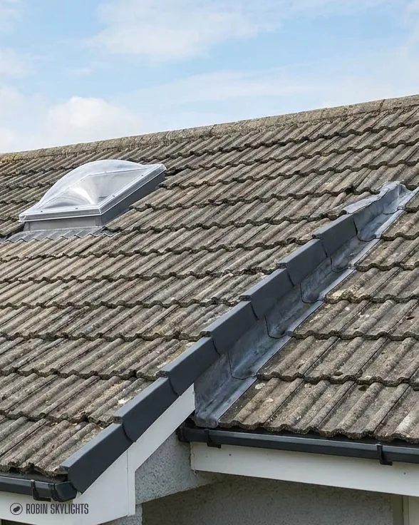 Sun tunnel dome on a concrete tiled roof