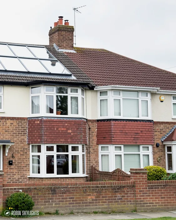 Brick semi-detached house with a roof window and front garden