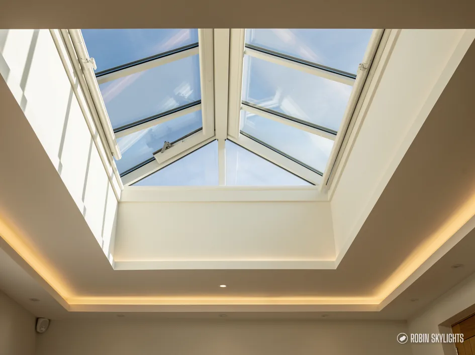 Roof lantern with opening vents set into a ceiling with a lit recess