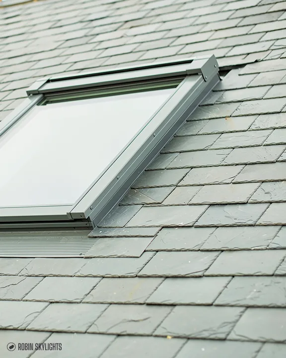 Roof window in a grey slate roof
